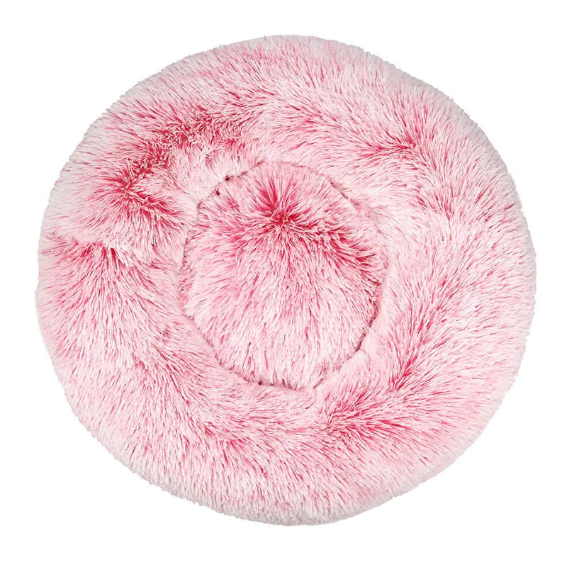 Pink fluffy pet bed on a white background