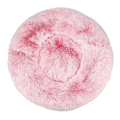 Pink fluffy pet bed on a white background
